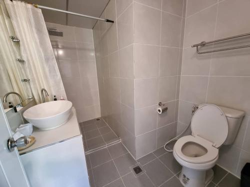 a bathroom with a toilet and a sink and a shower at On The Hill Karon Resort in Karon Beach
