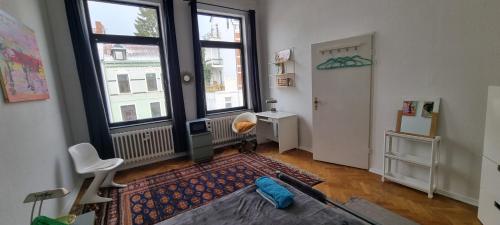a living room with a large window and a table and chairs at Apartment 11 A in BRE