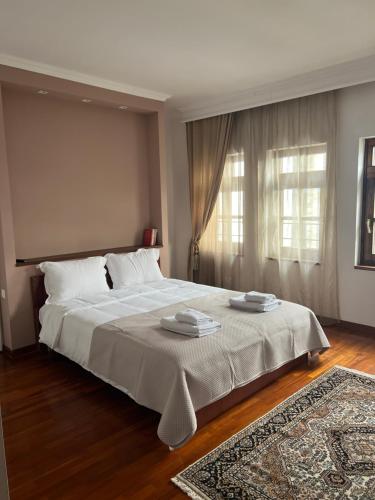 a bedroom with a large bed with two towels on it at Αρχοντικό Λίθος in Kastoria