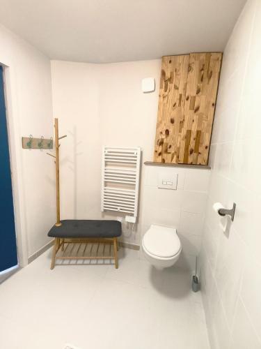 a bathroom with a toilet and a stool in it at Le Nautile - petit déjeuner - 10mn du Parc in Treize-Vents