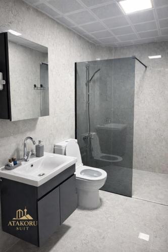 a bathroom with a toilet and a shower and a sink at ATAKORU Suit in Alacaatlı