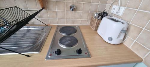 a kitchen counter with a stove and a toaster at Apartment 11 A in BRE