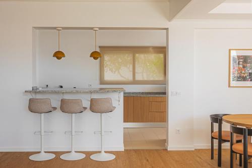 a kitchen with a counter and a table with chairs at Madeira High View in Funchal