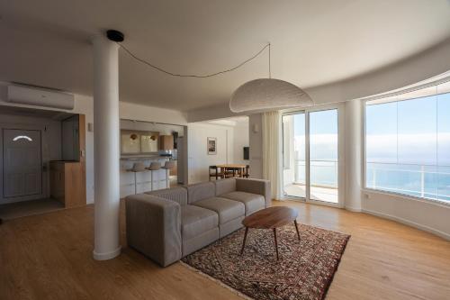 a living room with a couch and a table at Madeira High View in Funchal