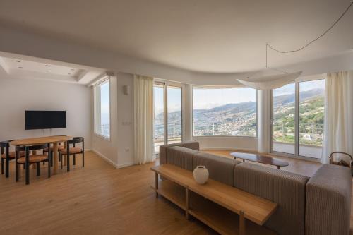 a living room with a couch and a table at Madeira High View in Funchal