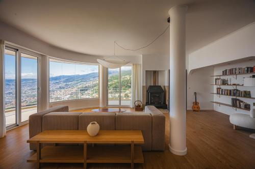 a living room with a couch and a table at Madeira High View in Funchal