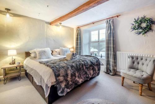 a bedroom with a bed and a chair and a window at 3 Bed in Nenthead oc-c34668 in Nenthead