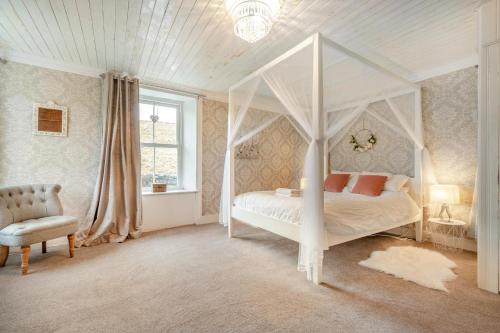 a bedroom with a white canopy bed and a chair at 4 Bed in Nenthead oc-c34669 in Nenthead