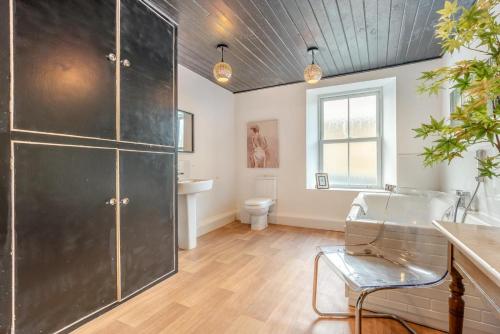 a bathroom with a black cabinet and a toilet at 4 Bed in Nenthead oc-c34669 in Nenthead