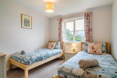 a bedroom with two beds and a window at 2 Bed in Coaley oc-s34729 in Coaley
