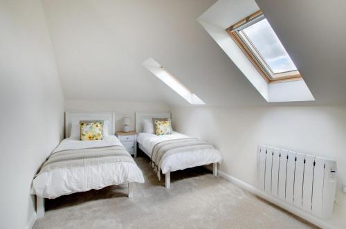 a attic bedroom with two beds and a skylight at 2 Bed in Newton oc-ffba in Newton
