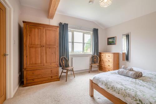 a bedroom with a bed and a dresser and a window at 2 Bed in Coaley oc-r34730 in Coaley