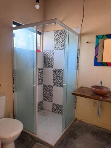 a bathroom with a shower with a toilet and a sink at Vila Macapaz Kitesurf in Luis Correia