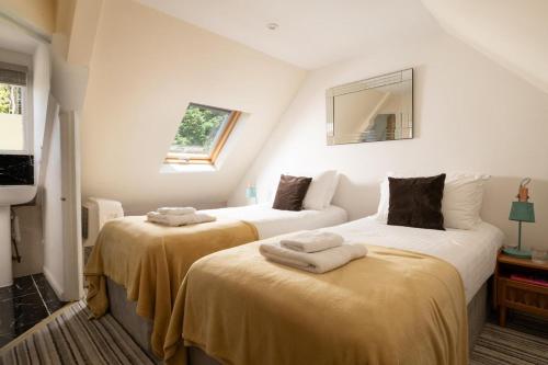two beds in a room with towels on them at 2 Bed in Alkham oc-a34787 in Swingfield