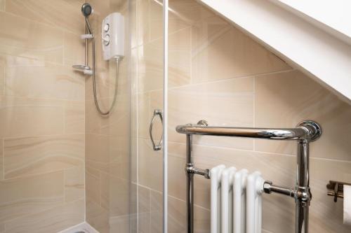 a shower in a bathroom with a glass door at 2 Bed in Alkham oc-a34787 in Swingfield