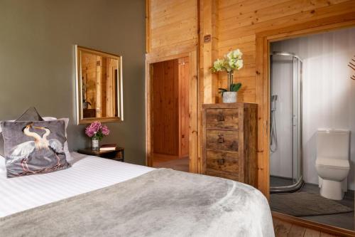 a bedroom with a bed and a bathroom with a shower at 6 Bed in Alkham oc-p34791 in Swingfield