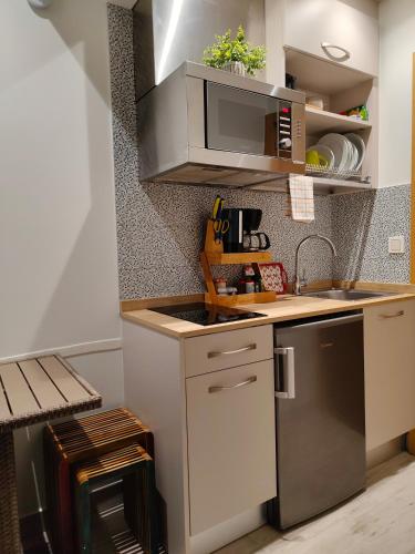 a small kitchen with a sink and a microwave at Gazteategi in Zarautz
