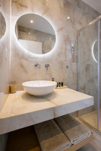 a bathroom with a sink and a mirror at Golden Gaia Villas in Kipía