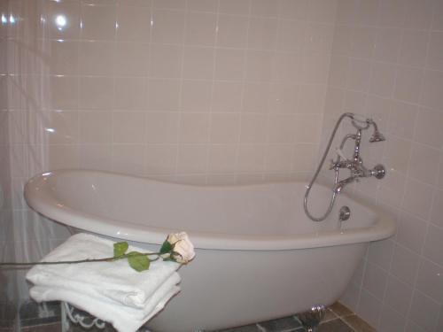 a bath tub in a bathroom with a towel at La Maison de Papé in Combas