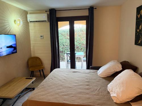 a bedroom with a bed and a table and a window at I Bugni in Sisco