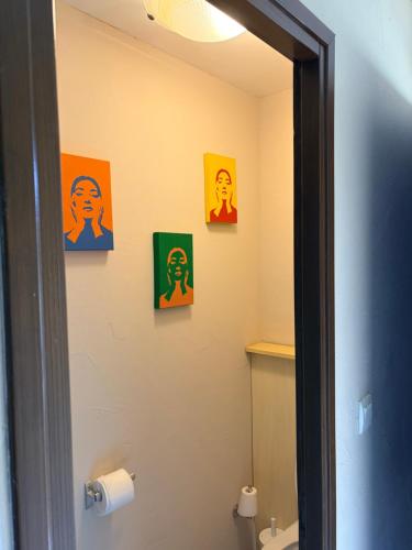 a bathroom with colorful pictures on the wall at I Bugni in Sisco