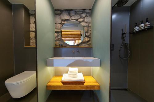a bathroom with a sink and a toilet and a mirror at 心墅 空间 in Dali