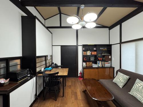 a living room with a table and a couch at Yamaguchi House Annex, Private House with Onsen in Hakone
