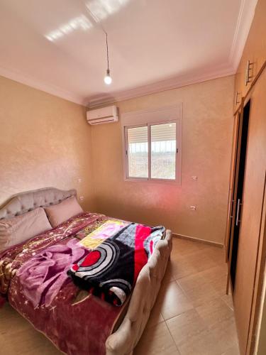 a bedroom with a bed and a window at Apartmen rentals with M Z in Marrakesh