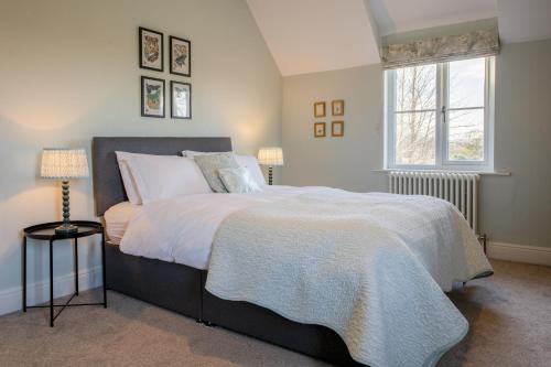 a bedroom with a large bed and a window at Green Balk Cottage in Stokesley