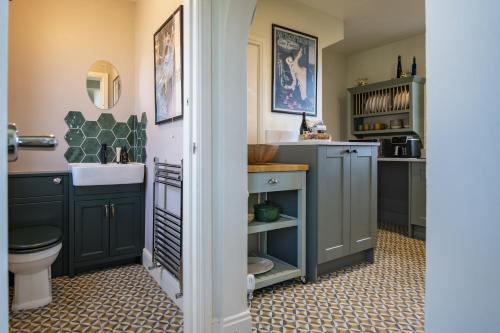 a bathroom with a sink and a toilet at Green Balk Cottage in Stokesley