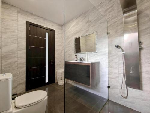 a bathroom with a toilet and a sink and a shower at Modern House with Pool - 10 Guests Max in Taʼ Ċantar