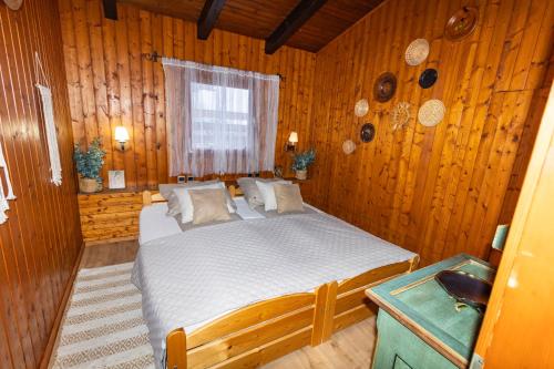 a bedroom with a bed in a wooden room at Apartment Schönblick in Verditz