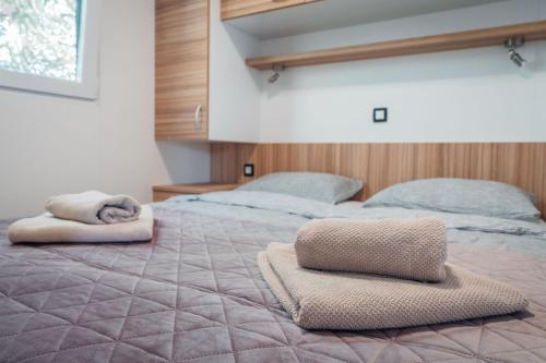 a bedroom with two beds with towels on top of it at House no 1 in Pakoštane