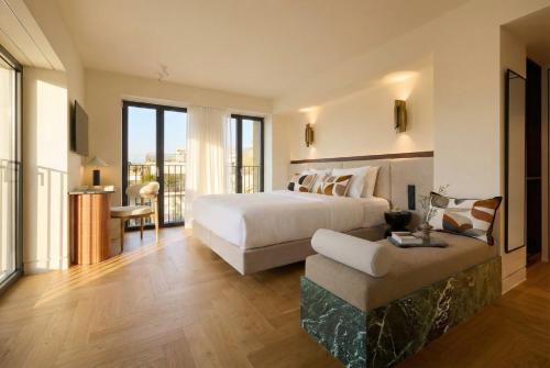 a bedroom with a large white bed and a couch at Bellén Athens Ηotel in Athens