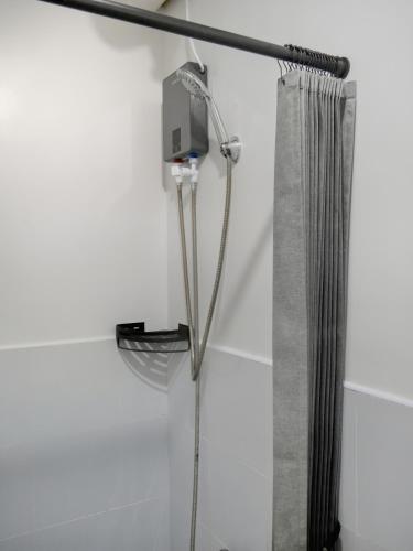 a shower in a bathroom with a shower curtain at LunaVista in Bankal