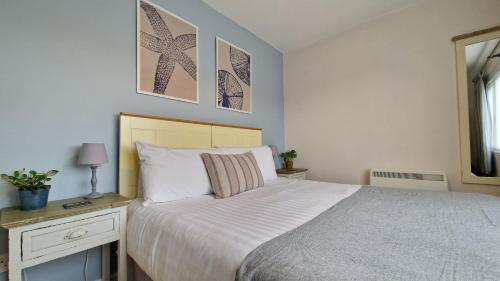 a bedroom with a bed and a table and a mirror at 7 The Burrows in Braunton