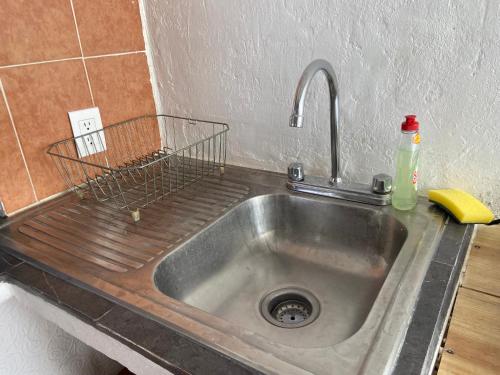 a kitchen sink with a drain in the middle at DEPA IXTLAN alberca y cerca de playa in Santa Cruz Huatulco