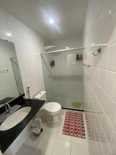 a bathroom with a shower and a toilet and a sink at Mar e Descanso in Guarapari