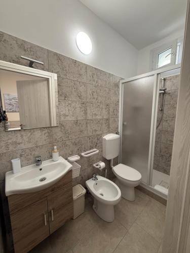 a bathroom with a sink and a toilet and a shower at Gio Rooms in Mazara del Vallo