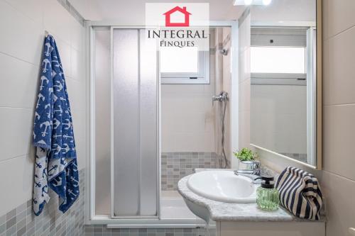a bathroom with a sink and a mirror at Why Not Apartment Palamós in Palamós