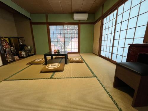 a room with mats on the floor in a room with windows at Free Rental Car Villa in Beppu