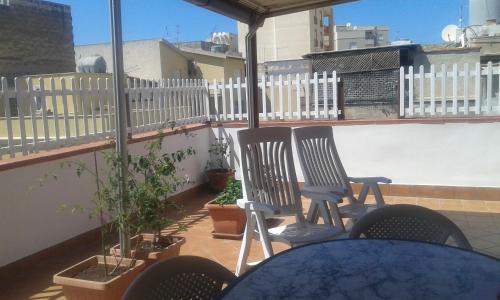 a patio with two chairs and a table on a balcony at Suite Marina in Trapani