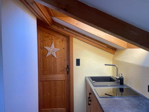 a kitchen with a sink and a wooden door at Landhaus Elisabeth in Krün