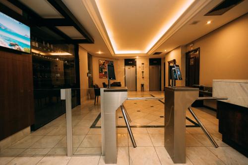 a restaurant with a lobby with tables and chairs at Eco Stay in Curitiba