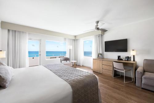 a hotel room with a bed and a television at Riu Plaza Miami Beach in Miami Beach
