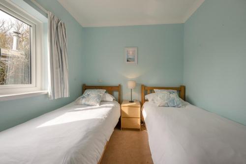 two beds in a room with a window at 2 Bed in Bishopston oc-h28996 in Bishopston