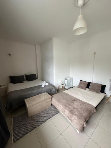 a bedroom with two beds and a rug at Apartamento cerca de la playa 8 in Vigo