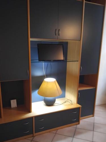 a lamp sitting on a table in a cabinet at Va Pensiero Cuore di Parma in Parma