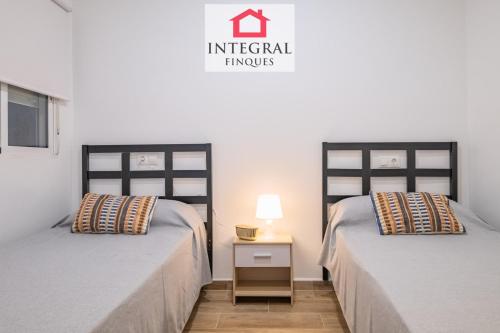 two beds sitting next to each other in a room at Apartament Marea Baixa in Palamós