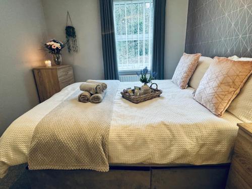 a bed with two teddy bears on top of it at New Road Apartment - 2 Bedrooms - Sleeps 3 in Whitehaven